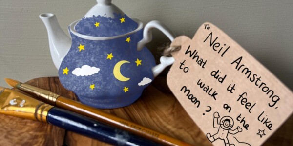 A teapot decorated with a painting of the sky at night. Attached is a brown label that reads 'Neil Armstrong. What did it feel like to walk on the moon?'.