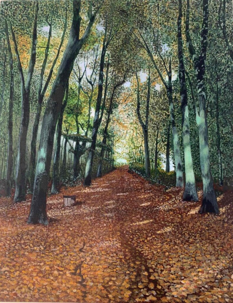 A forest pathway lined with tall trees, their foliage a mix of green and orange, suggesting an autumn setting. The ground is carpeted with fallen leaves, and the path stretches into the distance, creating a strong sense of depth.